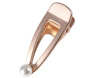 Detail of rose gold cutout hair clip featuring an elegant white pearl embellishment