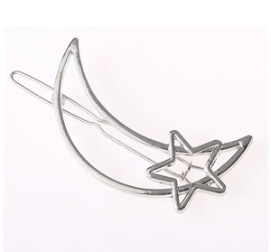 Detailed close-up of a silver hollow moon and star hair clip with a sleek metal finish