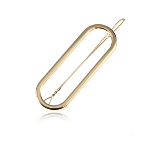 Minimalist matte gold oval cutout metal hair clip with a sleek polished finish for women
