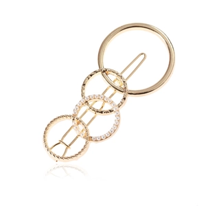 Elegant gold metal hair clip with four overlapping circles and white pearl accents