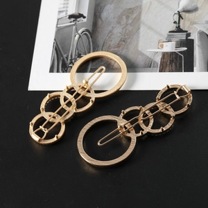 Elegant gold layered ring hair pins set with interlocking circles on creative background