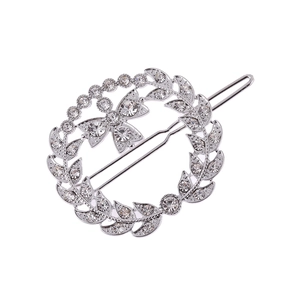 Silver vintage leaf wreath hair clip with crystal butterfly and pearls on white backdrop