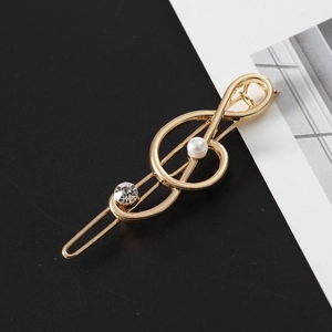 Goldene Notenschlüssel Haarklammer mit weißer Perle und Strass auf schlichtem Grund