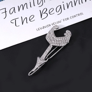 Sparkling silver cupid arrow hair clip with rhinestones and crescent moon design