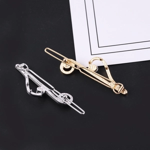 Polished musical note hair clips in gold and silver finish with textured embossing