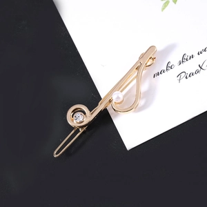 Elegant gold musical note hair clip with white pearl and rhinestone accents