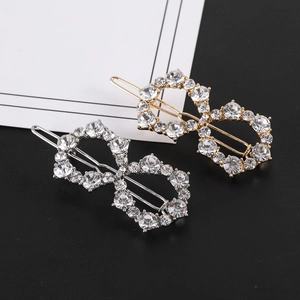 Detailed view of infinity figure 8 hair clips with gold and silver rhinestone inlay
