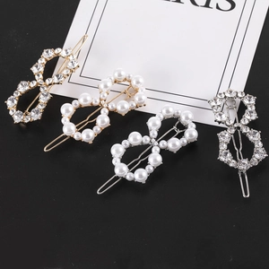 Set of four figure-eight hair clips with rhinestones and pearls in gold and silver