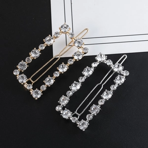 Detailed view of rectangular rhinestone hair clips with gold and silver metallic frames