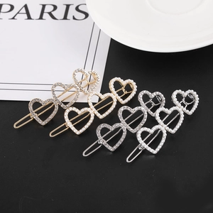 Barrettes à trois cœurs liés en or et argent avec des strass et des perles blanches