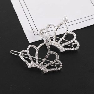Detail of silver crown hair clips with white pearls and sparkling rhinestones