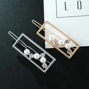 Macro shot of rectangular hollow hair clips with pearls and rhinestones in gold and silver