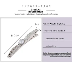 Detailed view of feather hair clip with pearl including size specs and material info