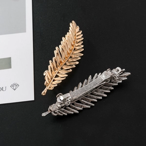Vintage gold and silver feather leaf hair clips with textured veins and spring fastener