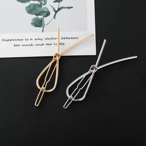Minimalist gold and silver teardrop metallic hair clips set on decorative white card