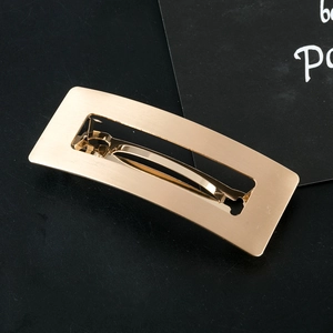 Matte gold hollow rectangular hair clip with a modern brushed metal finish for women