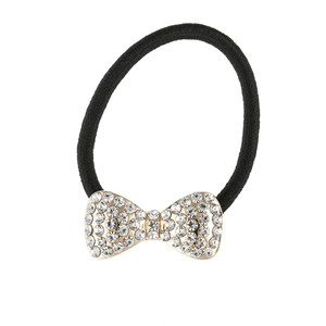 Detail of black elastic hair tie with sparkling rhinestone gold bow accessory