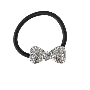 Close-up of black elastic hair tie with a sparkling silver rhinestone bow accessory