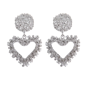 Silver hollow heart drop earrings with textured hammered finish on white background