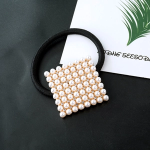 Square pearl hair tie with gold base and sparkling rhinestones on black elastic band