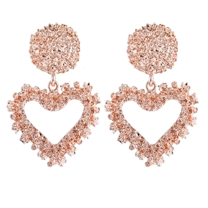 Close-up of rose gold heart drop earrings with intricate starburst textured surface
