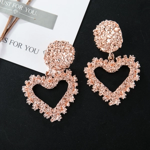 Exaggerated rose gold heart earrings with unique hammered texture and hollow design