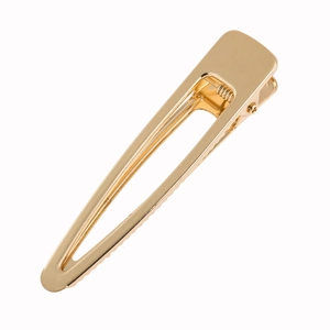 Golden brushed metal duckbill hair clip with minimalist spring mechanism and elegant finish