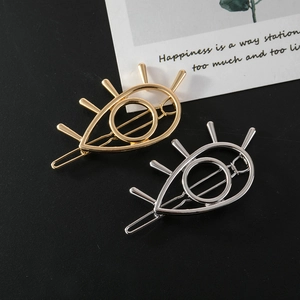 Set of gold and silver hollow evil eye hair clips with minimalist metal design