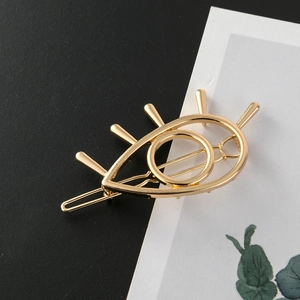 Minimalist gold metal evil eye hair clip with hollow out design and polished finish