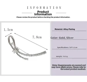 Detailed macro view of silver bow-knot alloy brooch with size specs and spiral texture