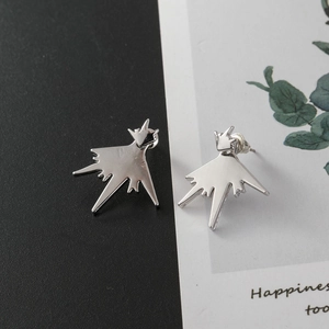 Macro detail of irregular silver geometric star stud earrings with a polished finish