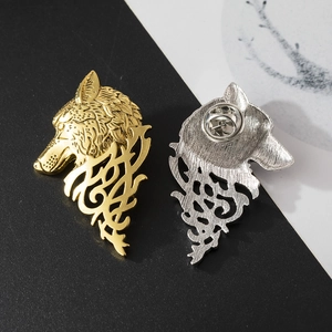 Detailed wolf head lapel pin in gold and silver finish with intricate hollowed patterns