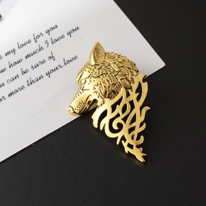 Polished gold wolf head totem brooch pin with intricate tribal details for unisex styling