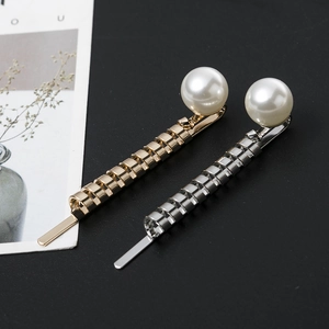 Elegant gold and silver twisted metal hairpins featuring large cream pearls on black background