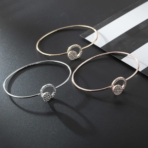 Three-piece set of thin metal bangles in gold, silver, and rose gold with pavé crystal rings