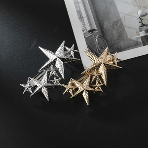 Set of gold and silver alloy star hair clips with textured hammered finish on black background