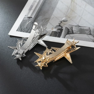 Star-shaped alloy hair clips in gold and silver finish with textured irregular design