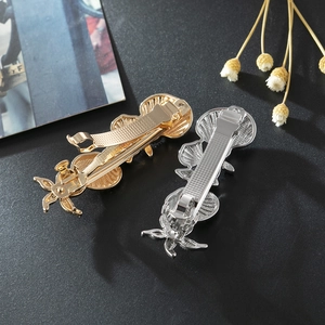 Vintage gold and silver scallop shell hair clips with embossed metallic texture