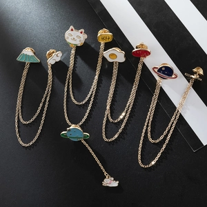 Detail of alloy enamel brooches featuring Japanese cartoon charms and gold chain links