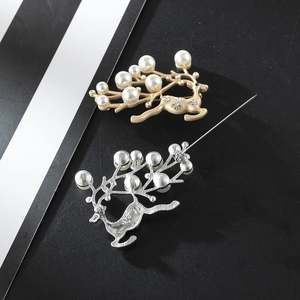 Detail of reindeer brooch showing pearl antlers, rhinestone body and pin back closure