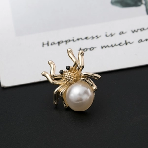 Golden spider brooch featuring a central pearl and sparkling crystal accents for women