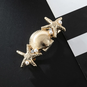 Elegant gold starfish and seashell hair clip with pearls and rhinestones on striped base