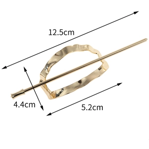Detail showing dimensions of gold alloy hair pin with hollow oval geometric design