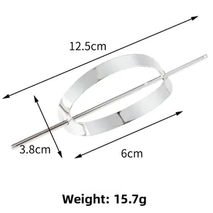 Detail view of oval hollow hair slide and pin set in polished silver metal finish