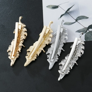 Irregular leaf metal hair clips in gold and silver finishes with fine feather texture