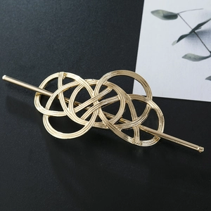 Detailed macro shot of vintage gold intertwined hollow metal hair stick accessory