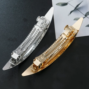 Polished gold and silver leaf-shaped spring hair clips with smooth metallic finish