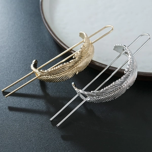 Elegant gold and silver feather-shaped hairpins with textured leaf designs