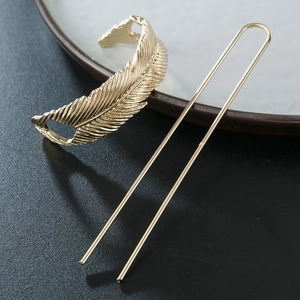 Elegant gold feather hair pin set with intricate texture and polished metal finish
