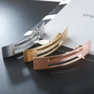 Close-up of minimalist hollow metal duckbill hair clips in gold, silver, and rose gold finish